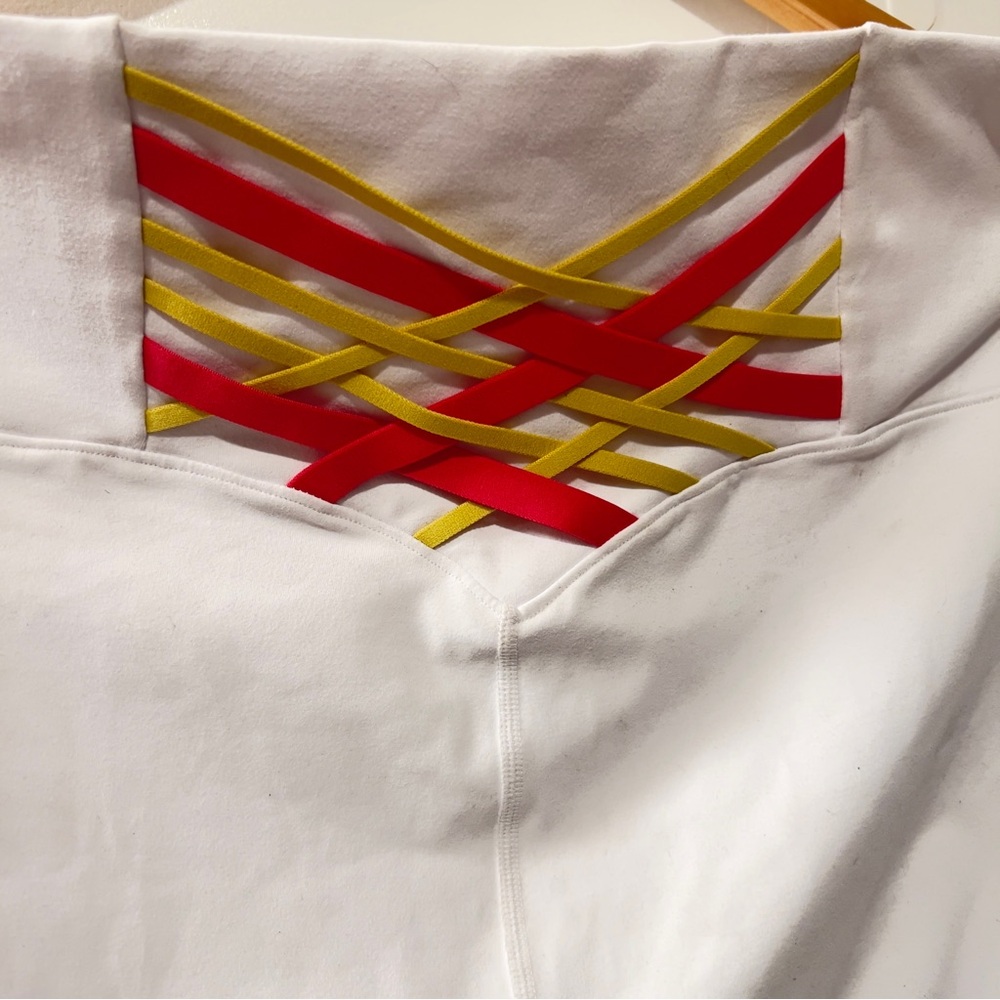 White Fabletics leggings with hot pink and Yellow Ribbon Detail on back